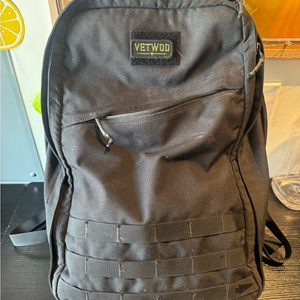 Black Tactical Backpack with MOLLE Webbing and Structured Design